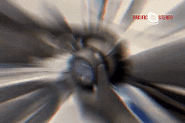 Blurred motion effect showing a technician handling a speaker during a car audio installation process, branded with the Pacific Stereo Fremont logo.