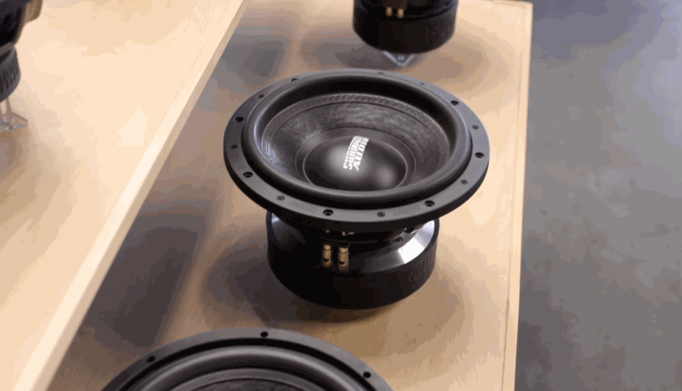 Close-up of a heavy-duty car audio subwoofer on display, with the Sundown Audio logo printed on the cone.