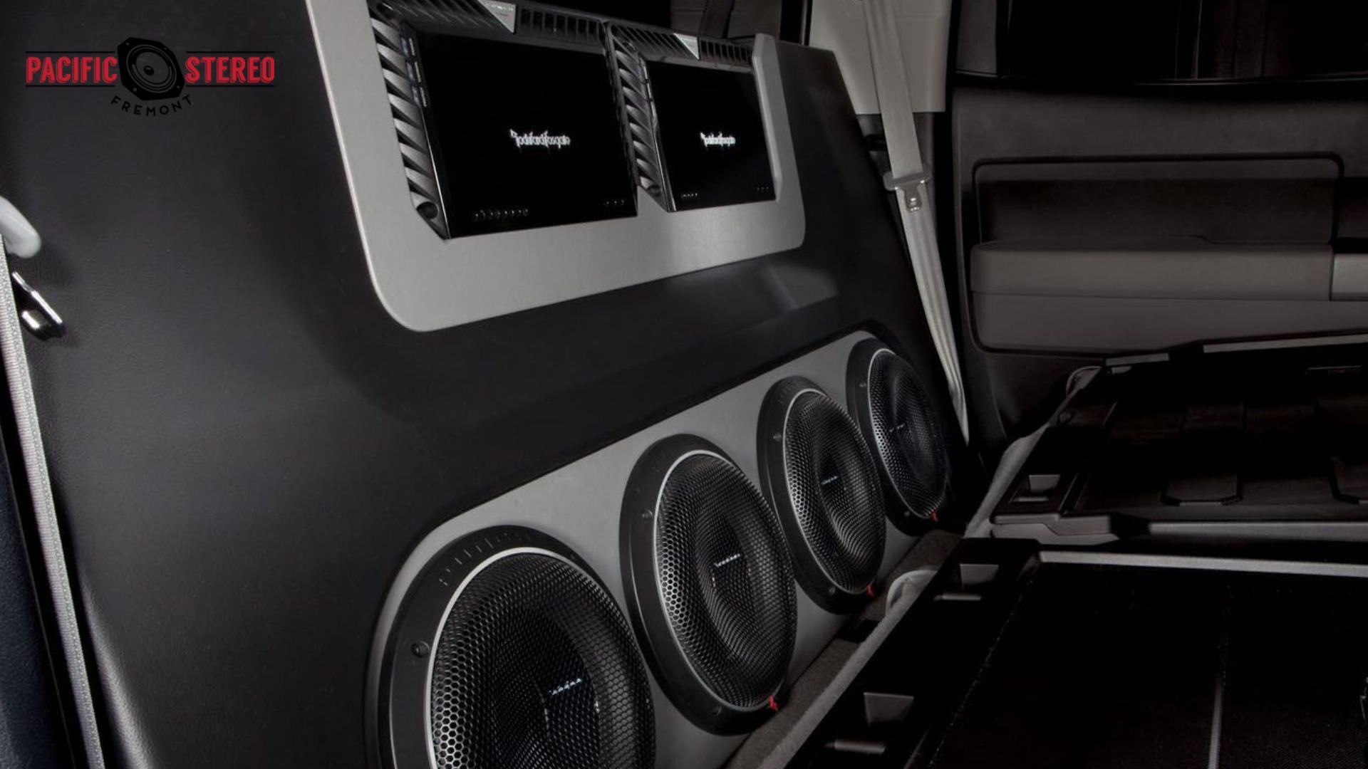 Custom vehicle interior featuring multiple speakers and amplifiers from a Best Car Audio setup