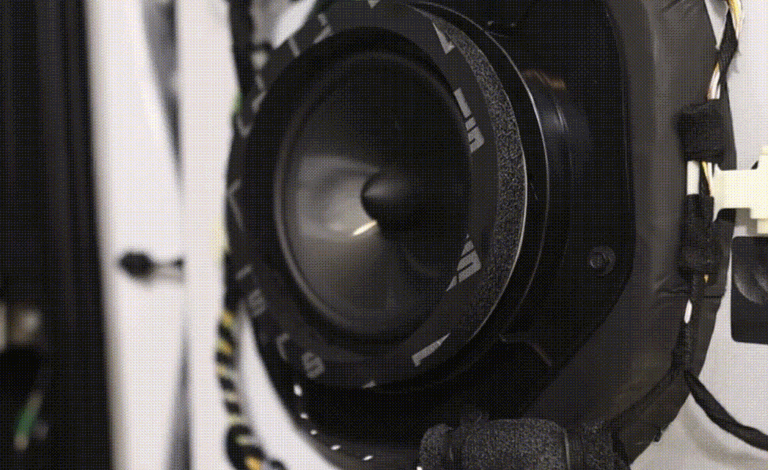 Close-up of Best Car Audio subwoofer installed inside a custom vehicle sound system enclosure